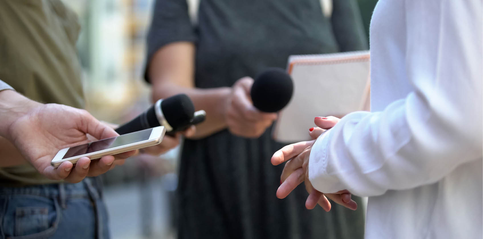 Woman gesticulating during interview with media, press conference, close-up